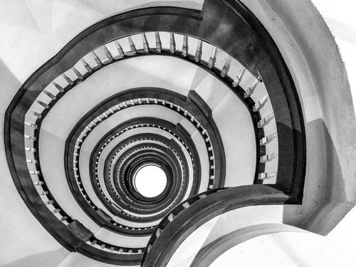 Free Captivating black and white shot of a spiraling staircase in Hamburg, showcasing dramatic symmetry and perspective. Stock Photo