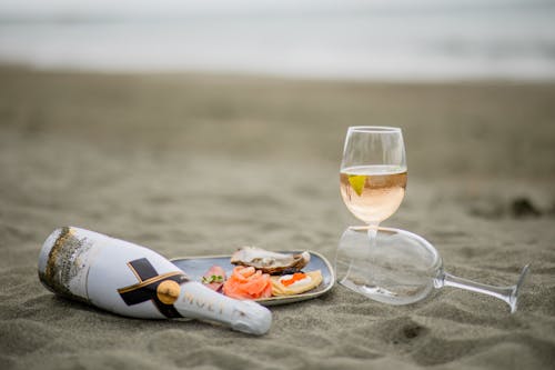 Bottle and Glasses of Champagne on Beach