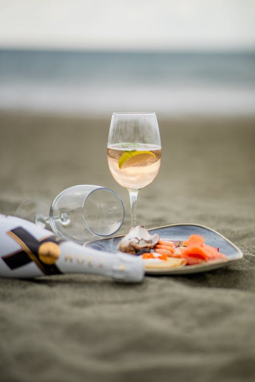 Glasses of Champagne and Plate on Beach