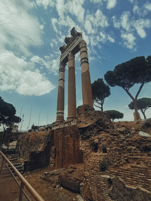 Free Stunning view of ancient Roman Forum ruins with classical columns under a bright sky. Stock Photo