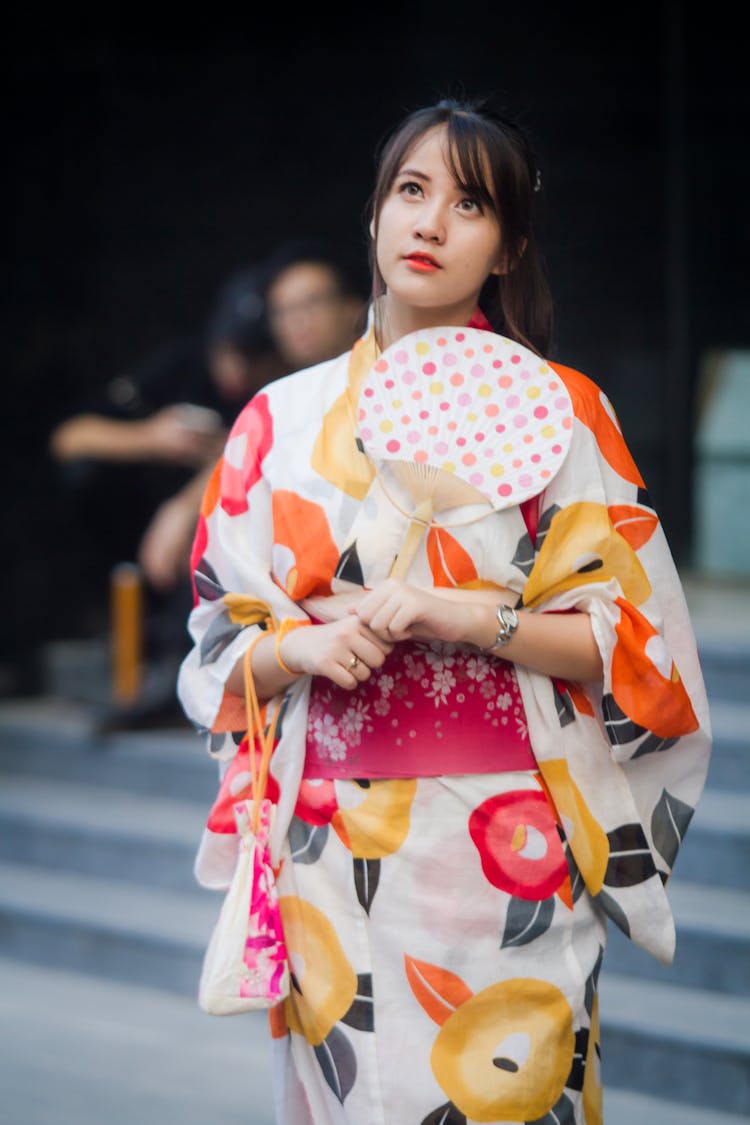 Woman Holding White And Brown Hand Fan