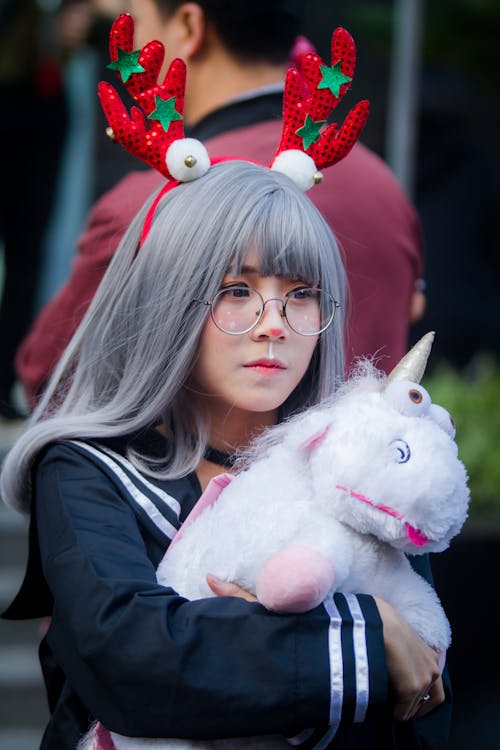 Free Woman Holding Unicorn Plush Toy Stock Photo