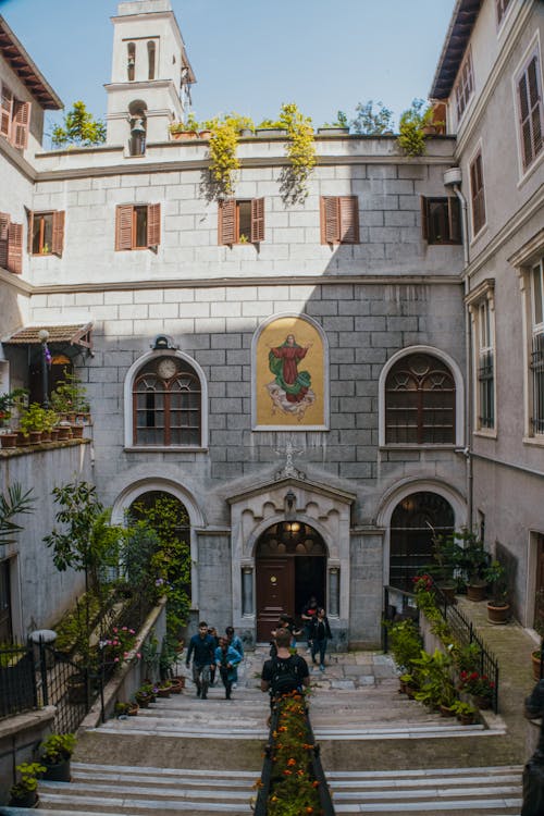A courtyard with stairs and a painting on the wall