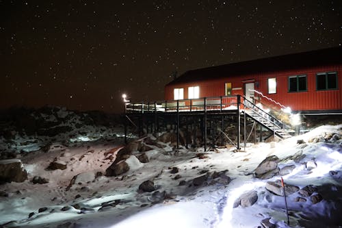 Snow around Building in Village in Winter at Night