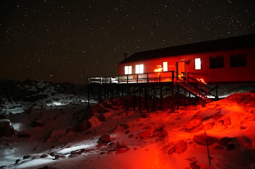 Building in Red Light and under Stars at Night