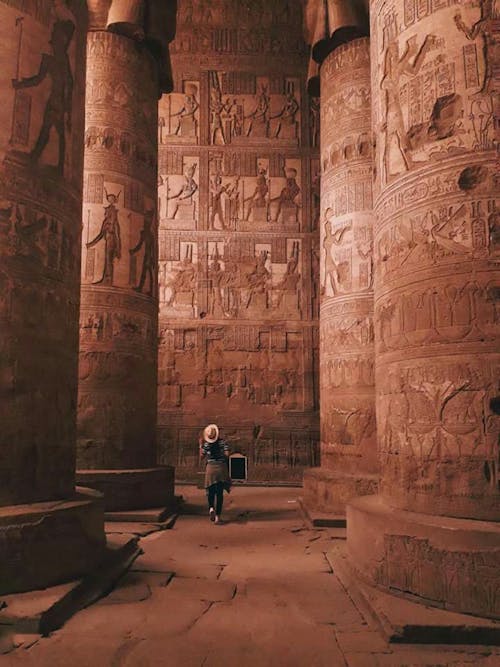 Free A Tourist Looking at Pillars inside the Dendera Temple Stock Photo