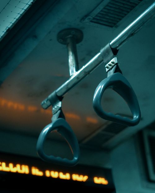 Free Close-up of handles inside public transportation with selective lighting. Stock Photo