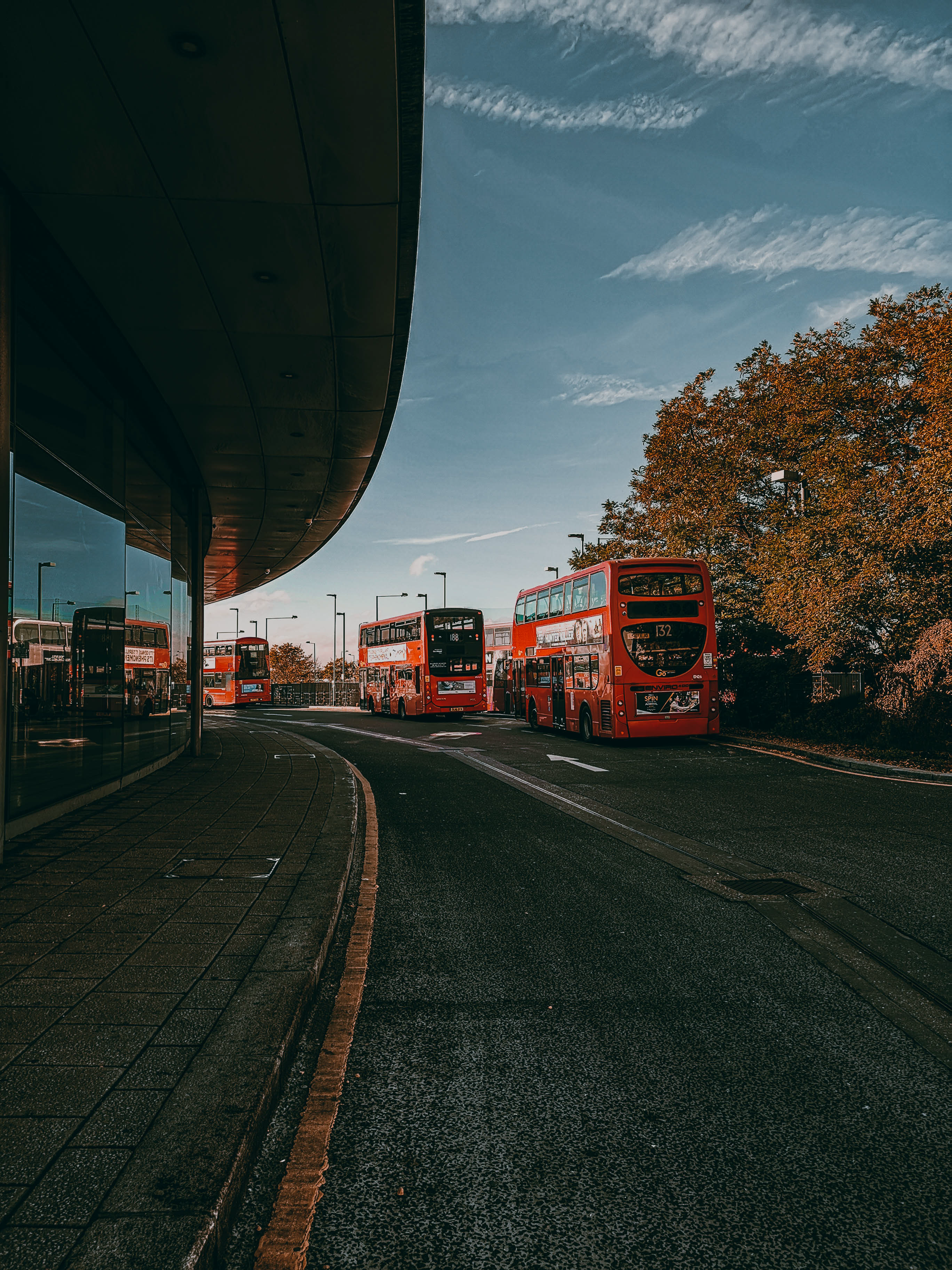 Two double decker buses are parked in front of a building · Free Stock ...