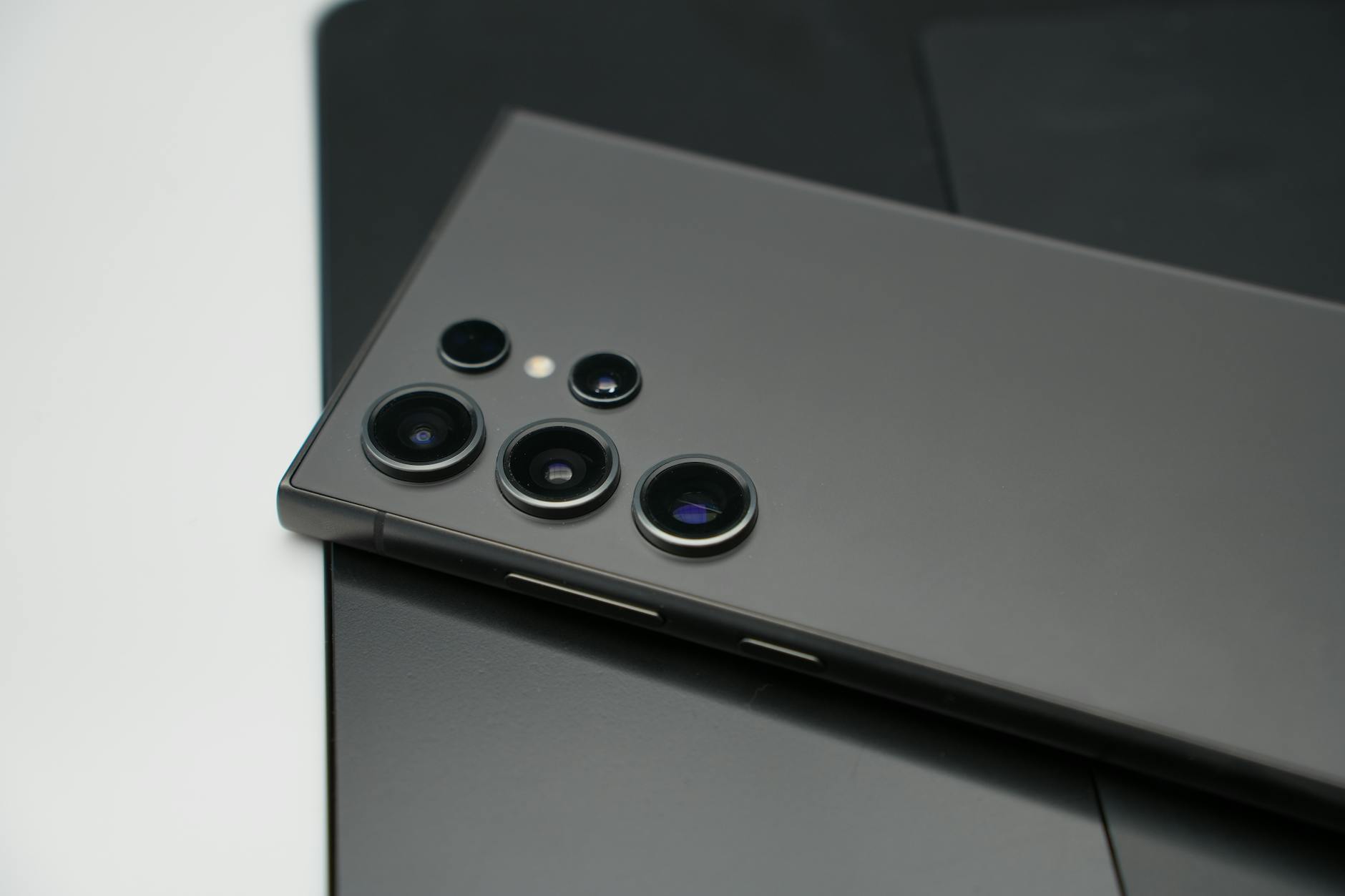 Detailed close-up of smartphone camera lenses, highlighting sleek design and technology.