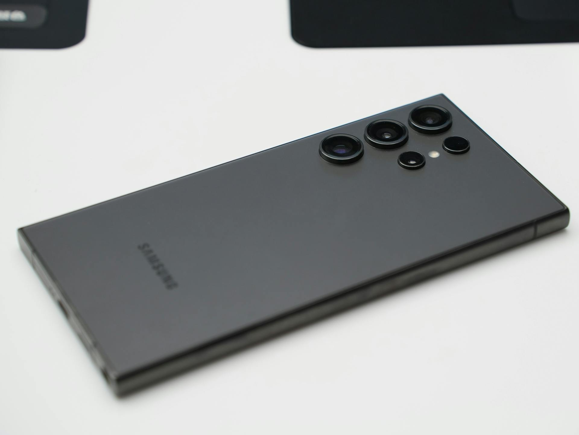 Detailed close-up shot of a sleek Samsung smartphone highlighting its advanced camera lenses.