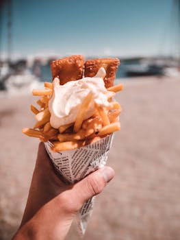 Delicious fish and chips served in a newspaper cone, perfect summer beach food.