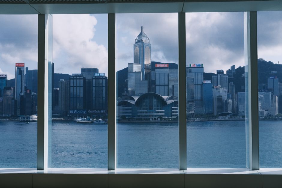 Captivating view of Hong Kong's skyline and waterfront from a modern interior.