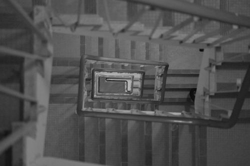 Free A dramatic black and white spiral staircase from a top view, showcasing intricate patterns. Stock Photo
