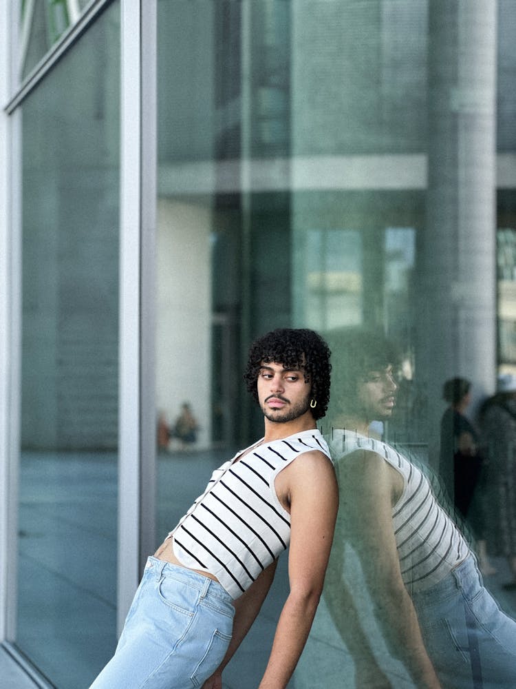 Man Leaning Against Glass Window