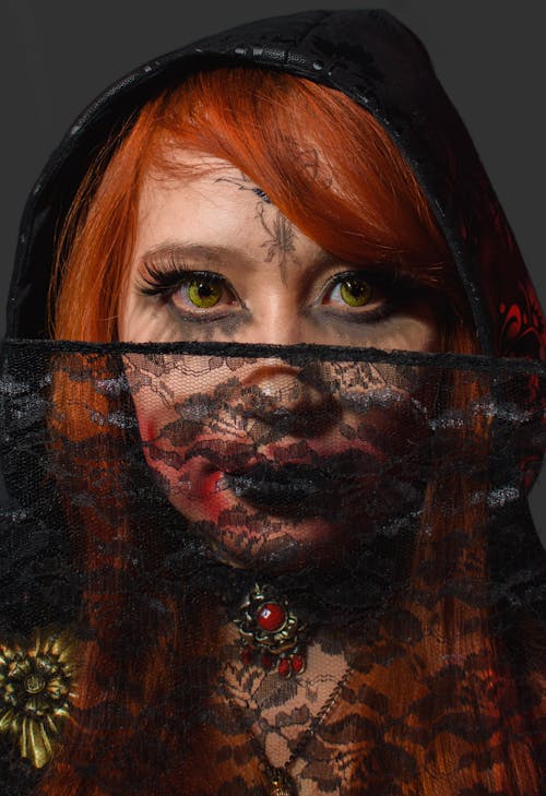 A woman with red hair and black makeup