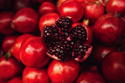 A close up of pomegranates with black seeds