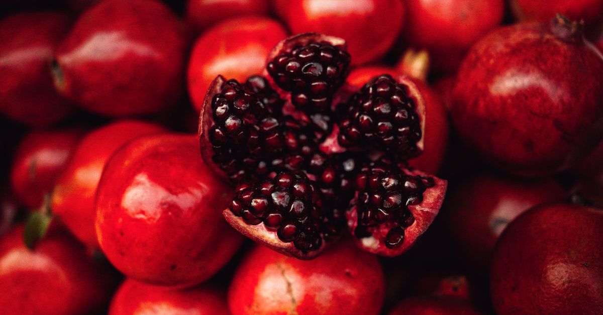 Fresh pomegranates vividly captured in a market setting. - Evidence evidence guide for pomegranate seed oil postprandial lipemia endothelial function randomized trial