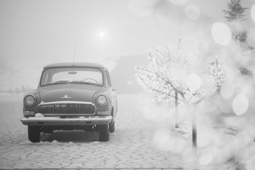 Classic GAZ-21 car amidst snowy fog, evoking nostalgic vintage winter scenes.