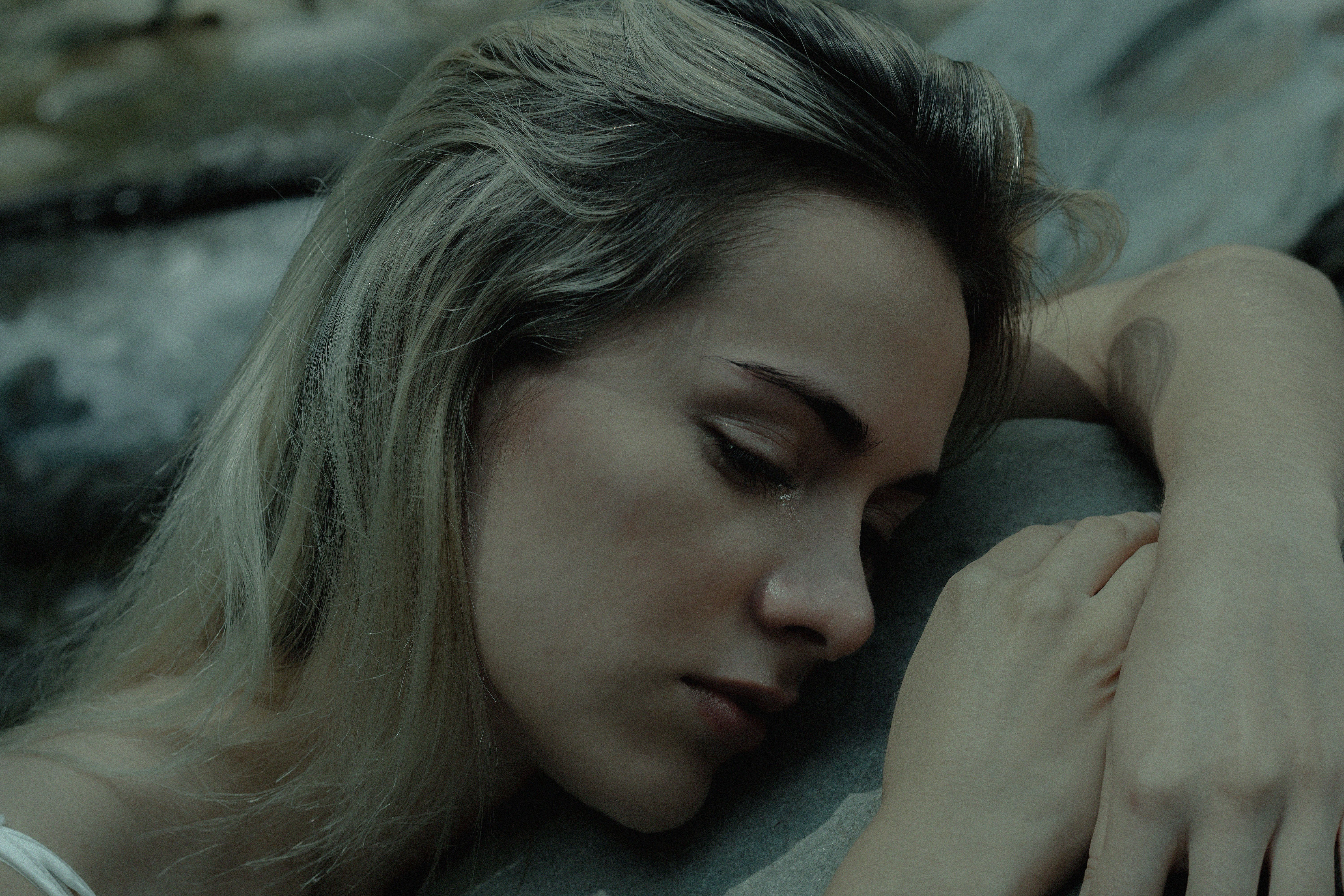 Young Woman Lying and Crying · Free Stock Photo