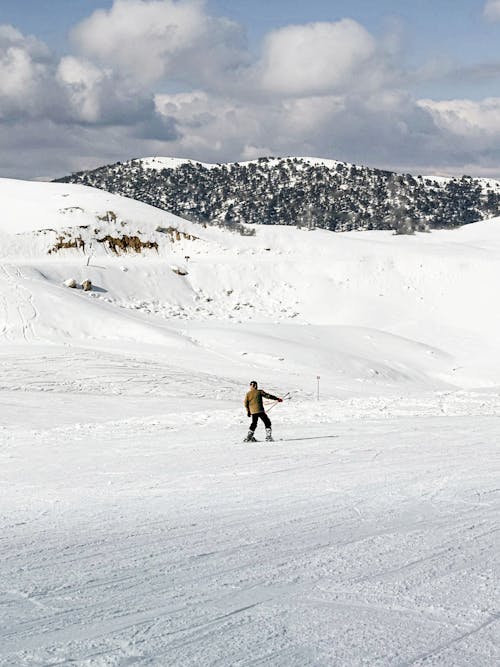 A person is riding a snowboard down a snowy slope