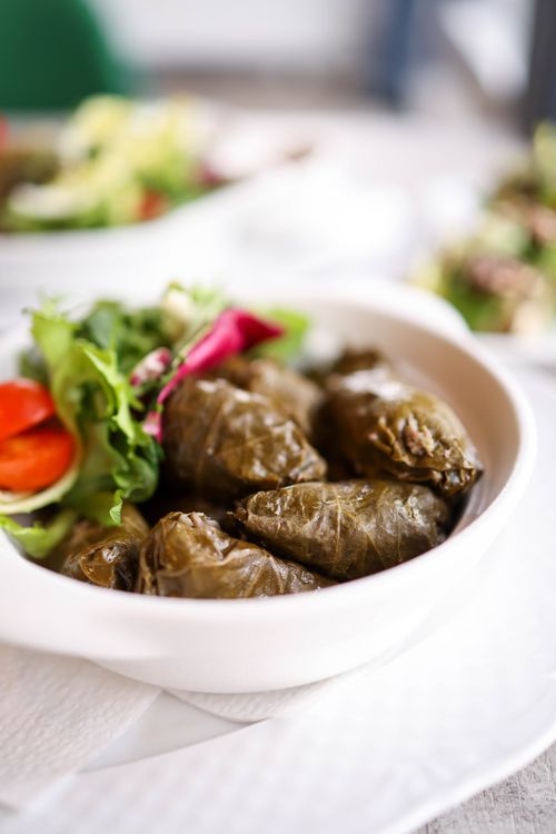 Free A bowl of Greek dolmas served with fresh salad, perfect for a healthy meal. Stock Photo