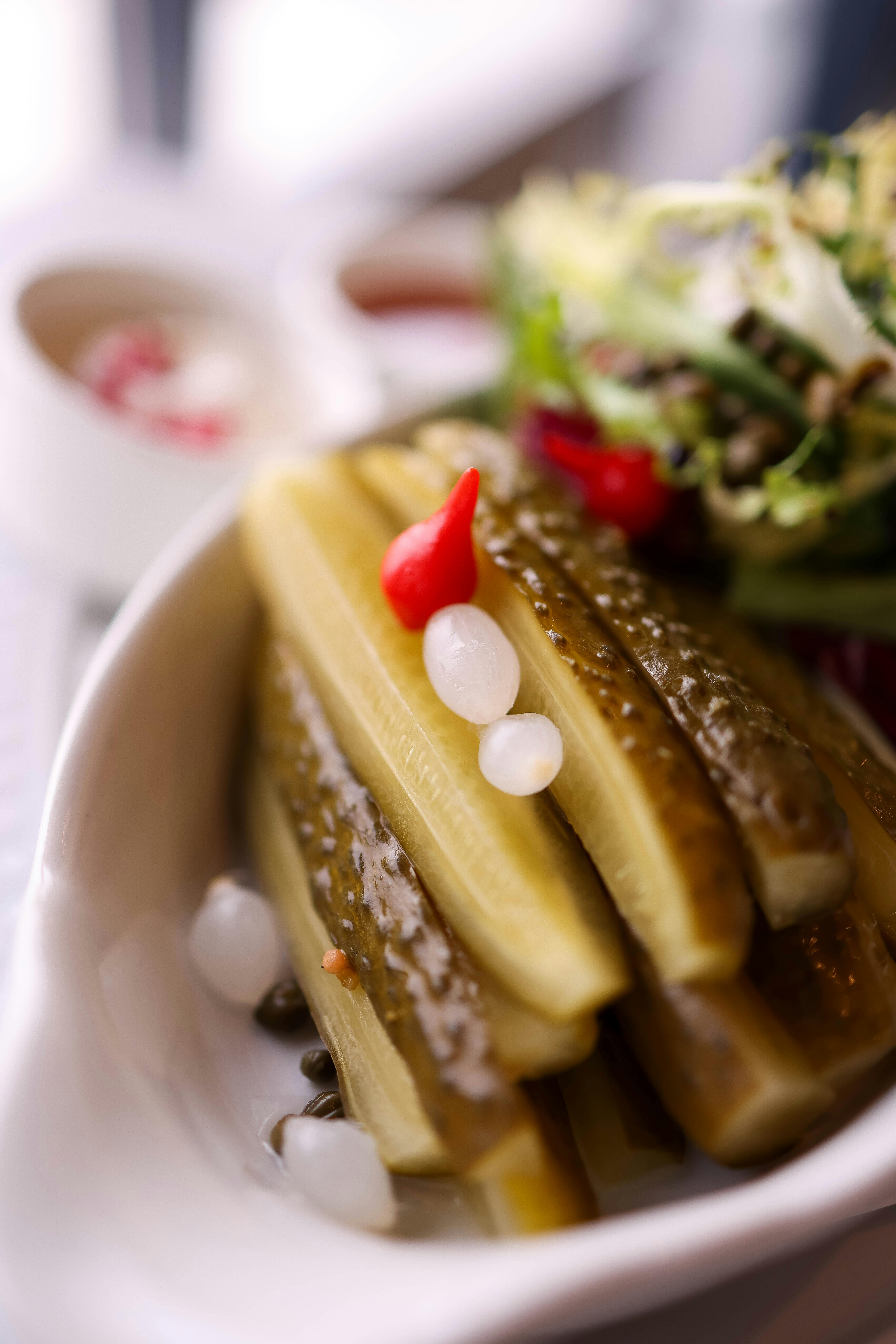 A close-up shot of a colorful plate featuring various fermented vegetables and sauces.