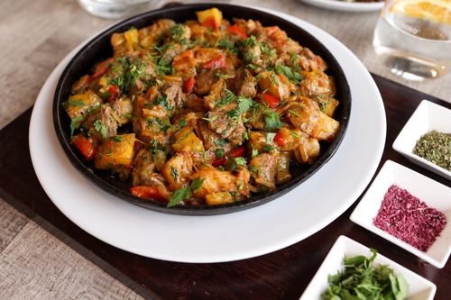 Free Delicious Indian curry with colorful spices and herbs served in a rustic setting. Stock Photo