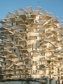 Explore this stunning geometric architectural marvel with layered balconies, creating a modern and artistic residential building.