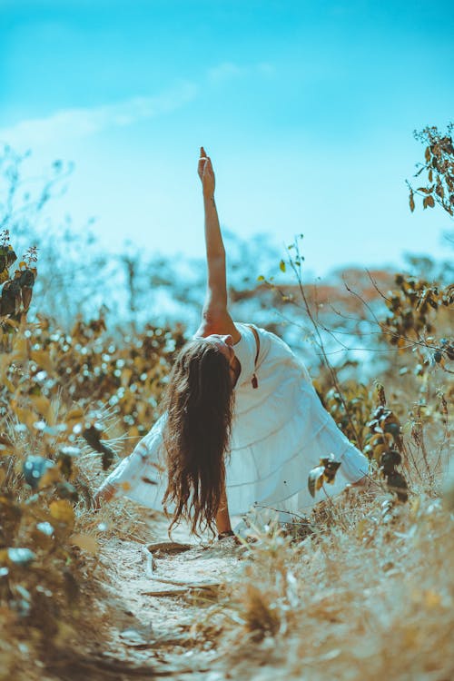 Free Woman Spreading Legs and Touching Ground Using Right Hand Stock Photo