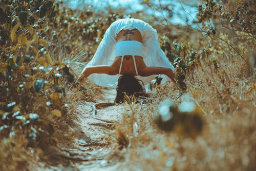 Woman Wearing White Dress Doing Head Stand