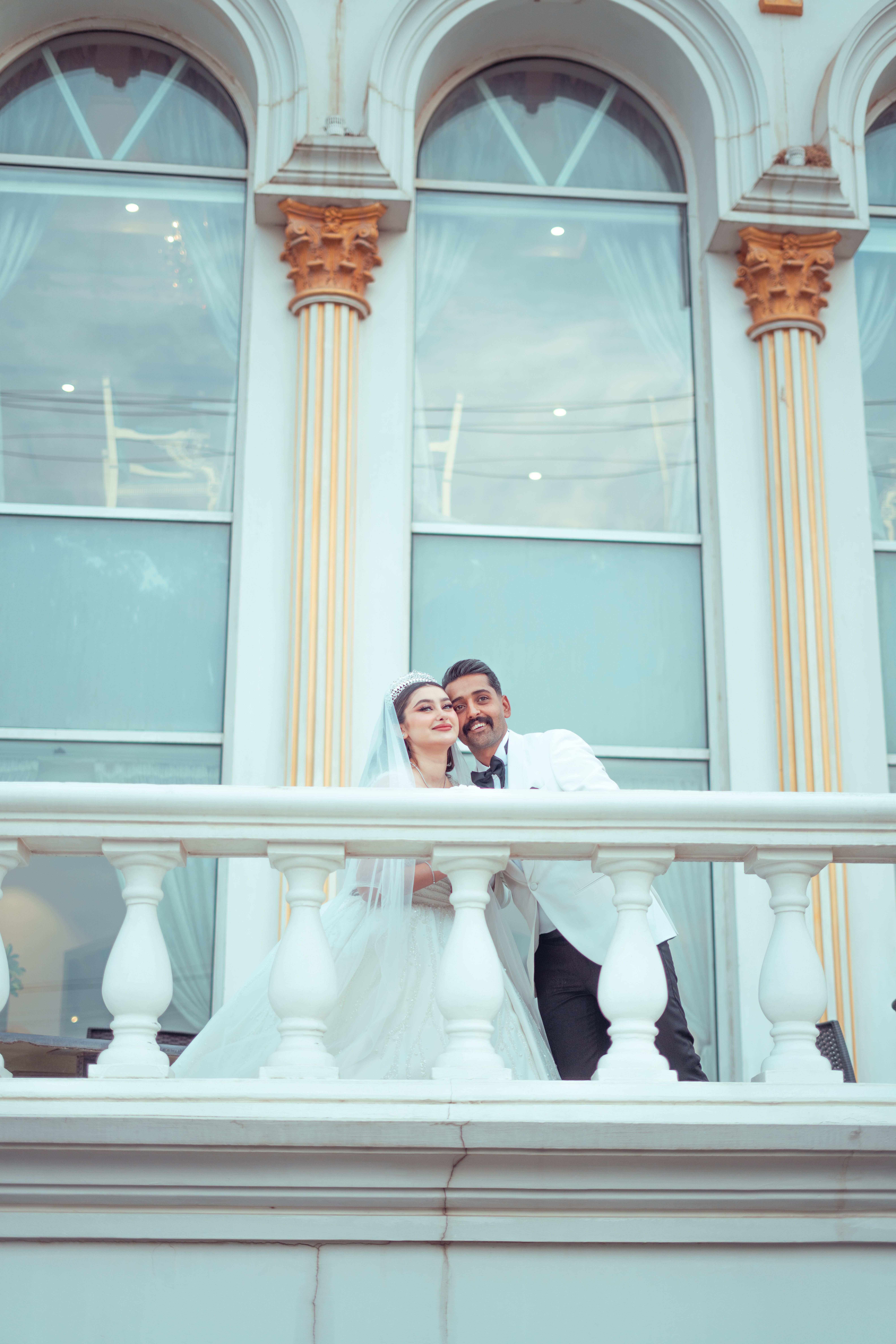 Newlyweds Sitting behind Railing · Free Stock Photo