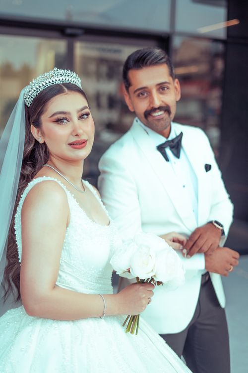 Free Bride and groom in elegant attire pose in outdoor wedding portrait in Baghdad, Iraq. Stock Photo