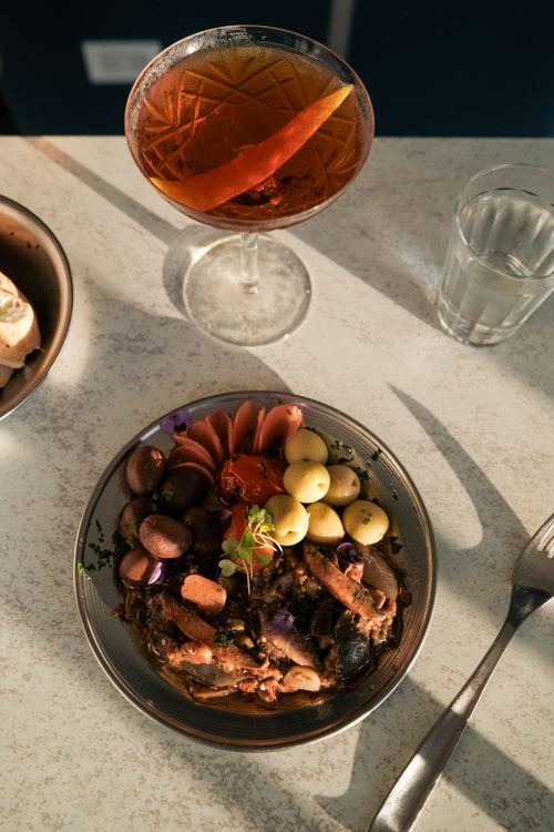 Free Elegant gourmet meal with a cocktail on a marble table in natural light. Stock Photo