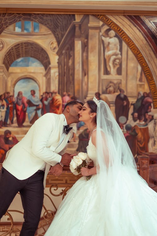 Newlyweds Kissing with Painting behind