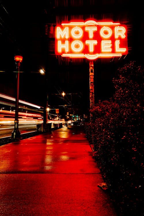 A neon sign for motor hotel in the middle of the night