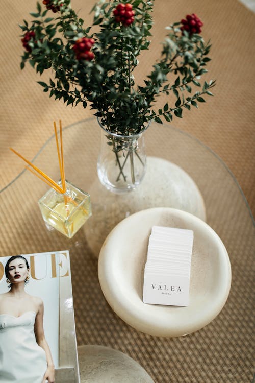 A magazine and a vase on a coffee table