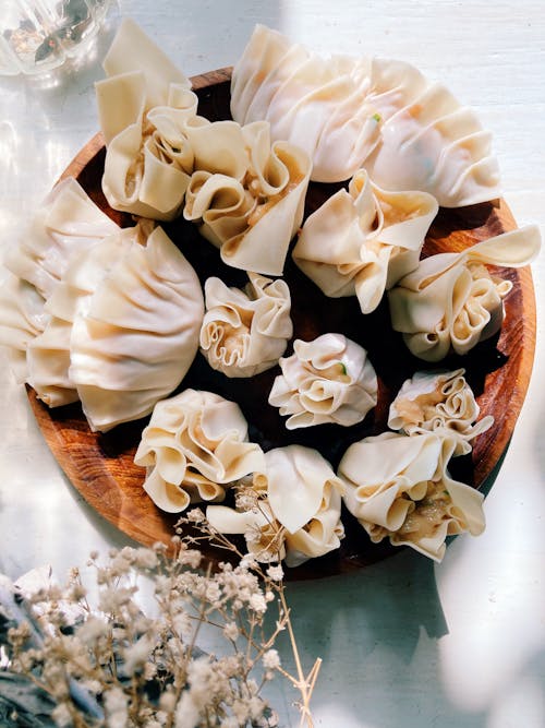 A bowl of dumplings with flowers on top
