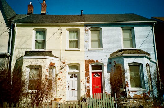 Colonial-style brick houses in Toronto with rustic charm, featuring distinct red and white doors.