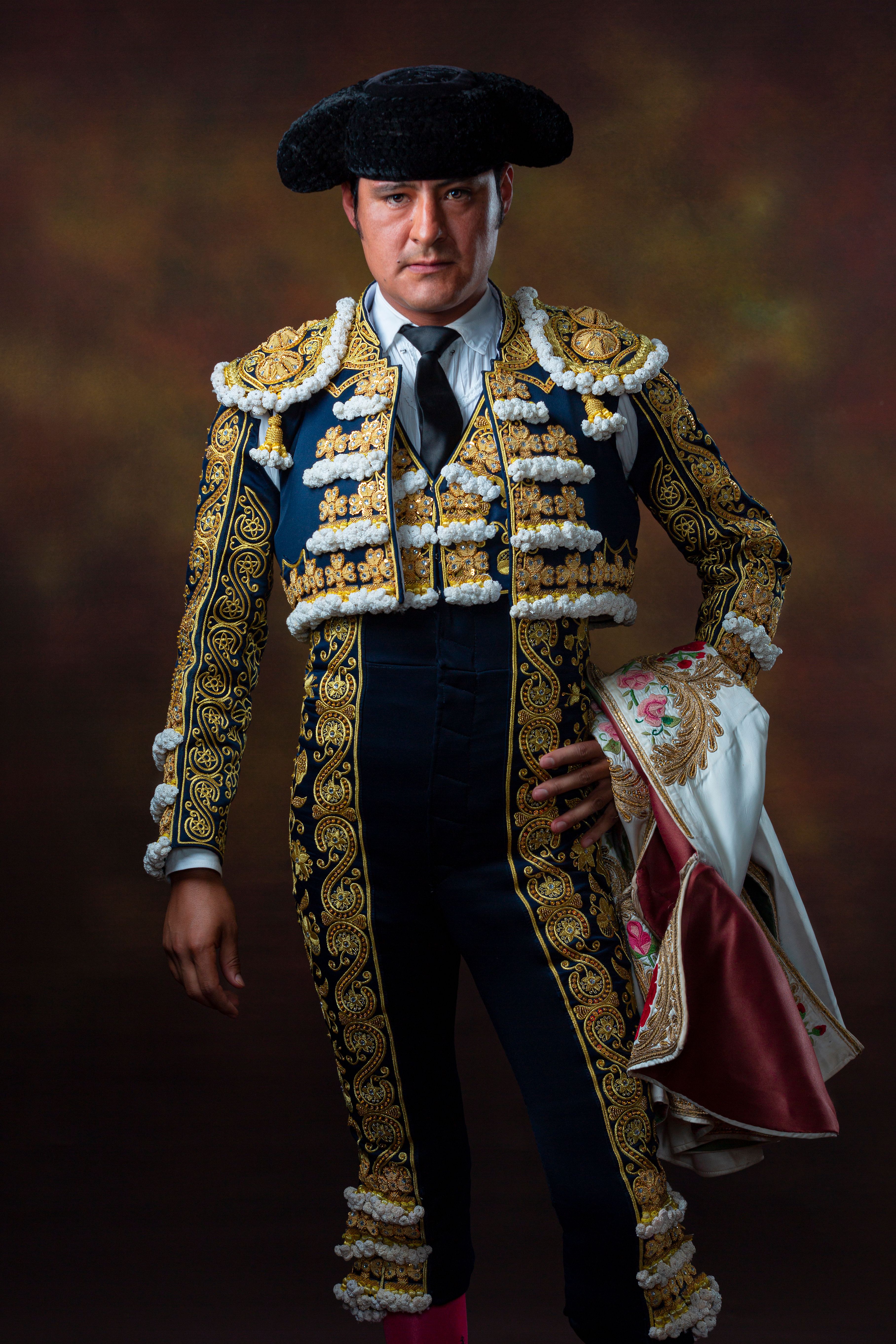 Elegant portrait of a man in ornately decorated traditional bullfighting costume.