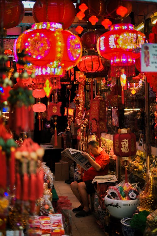 A woman is reading a newspaper in a market