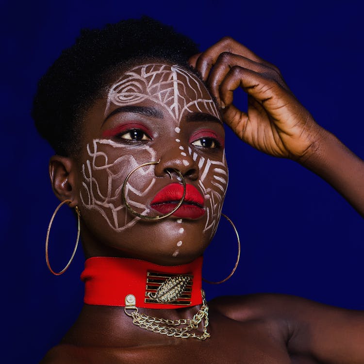 Woman With Nose Ring and Earrings Touching Her Hair