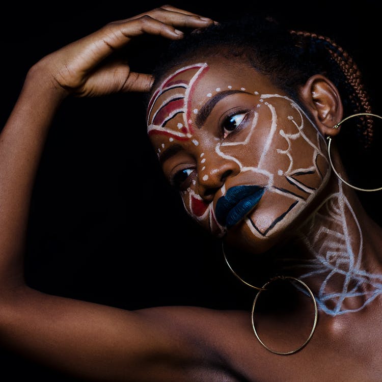 Woman With Face Paint Wearing Silver-colored Hoop Earrings