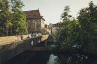 在一座历史悠久的欧洲城市，河上有座桥，人们正享受着阳光明媚的一天