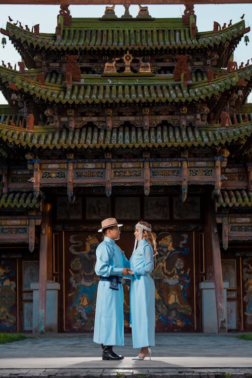 Couple Standing in Traditional Clothing by Buddhist Temple