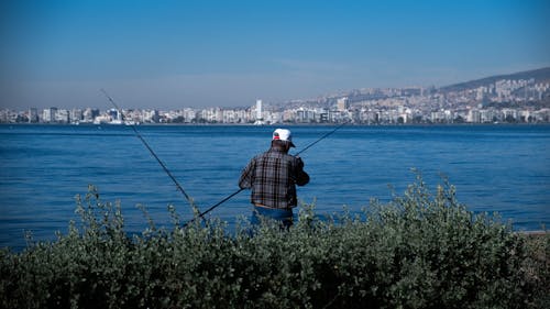 Fisherman on Sea Coast in City