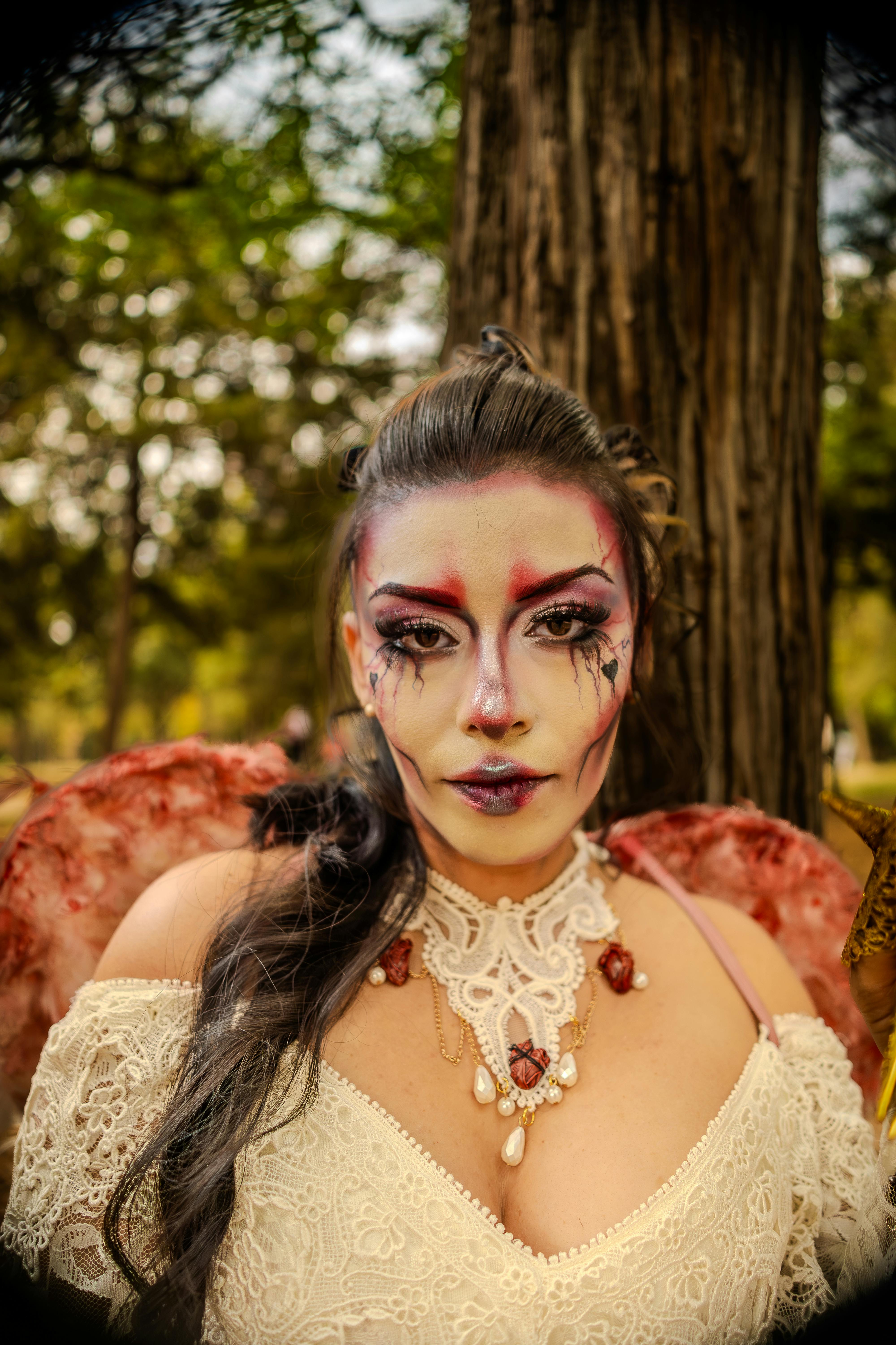 A mystical portrait of a woman dressed as an enchanted fairy in a serene woodland setting.