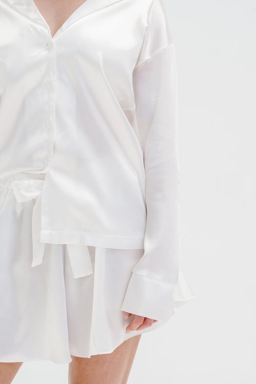 Free Elegant white satin sleepwear showcasing comfort and style for cozy nights. Stock Photo