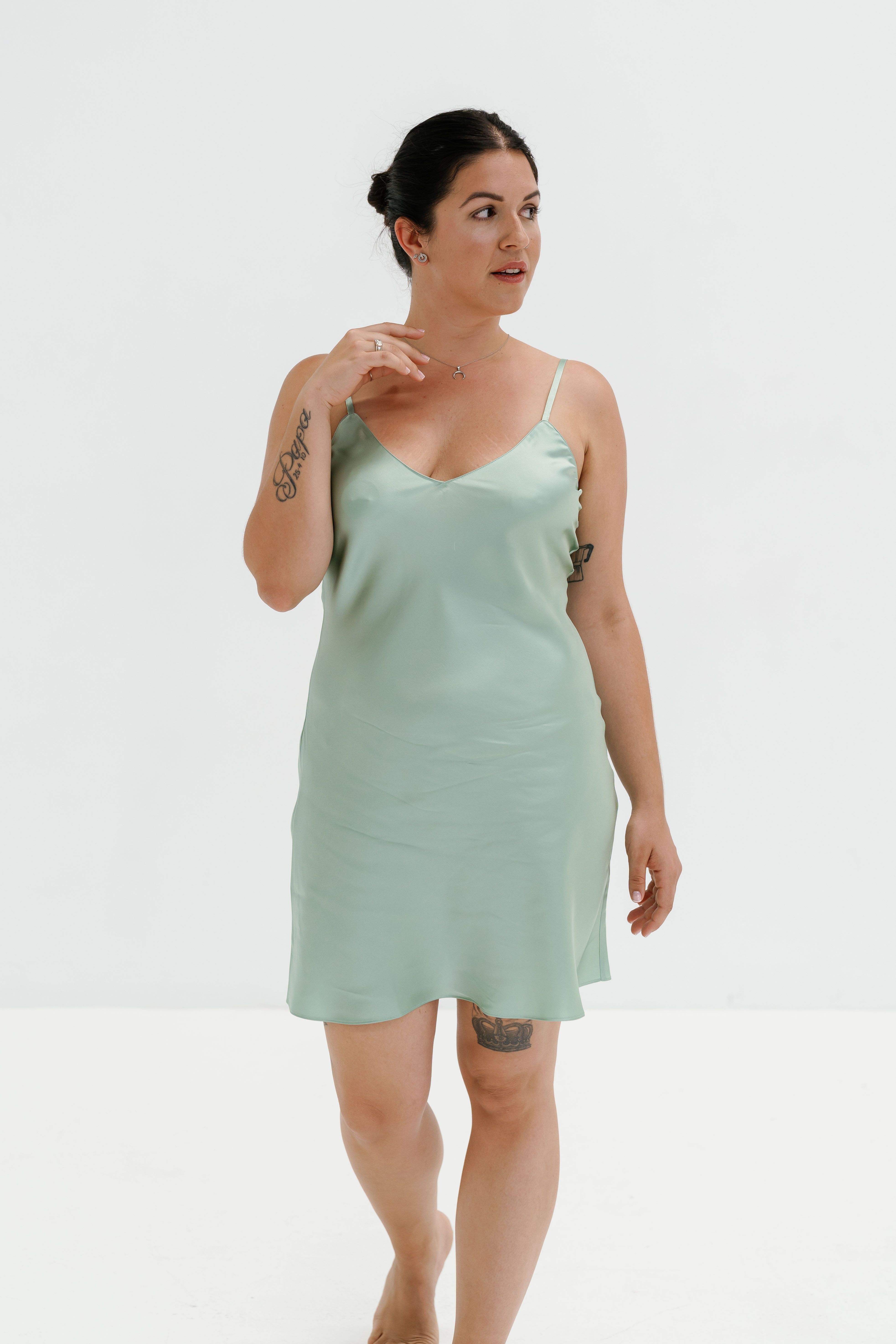 A woman in a green satin slip dress  Free Stock Photo