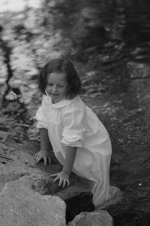 Girl in Dress Standing in Water