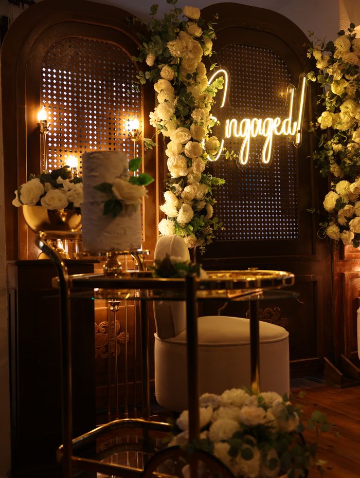 Engagement lounge decorated with flowers and warm lighting